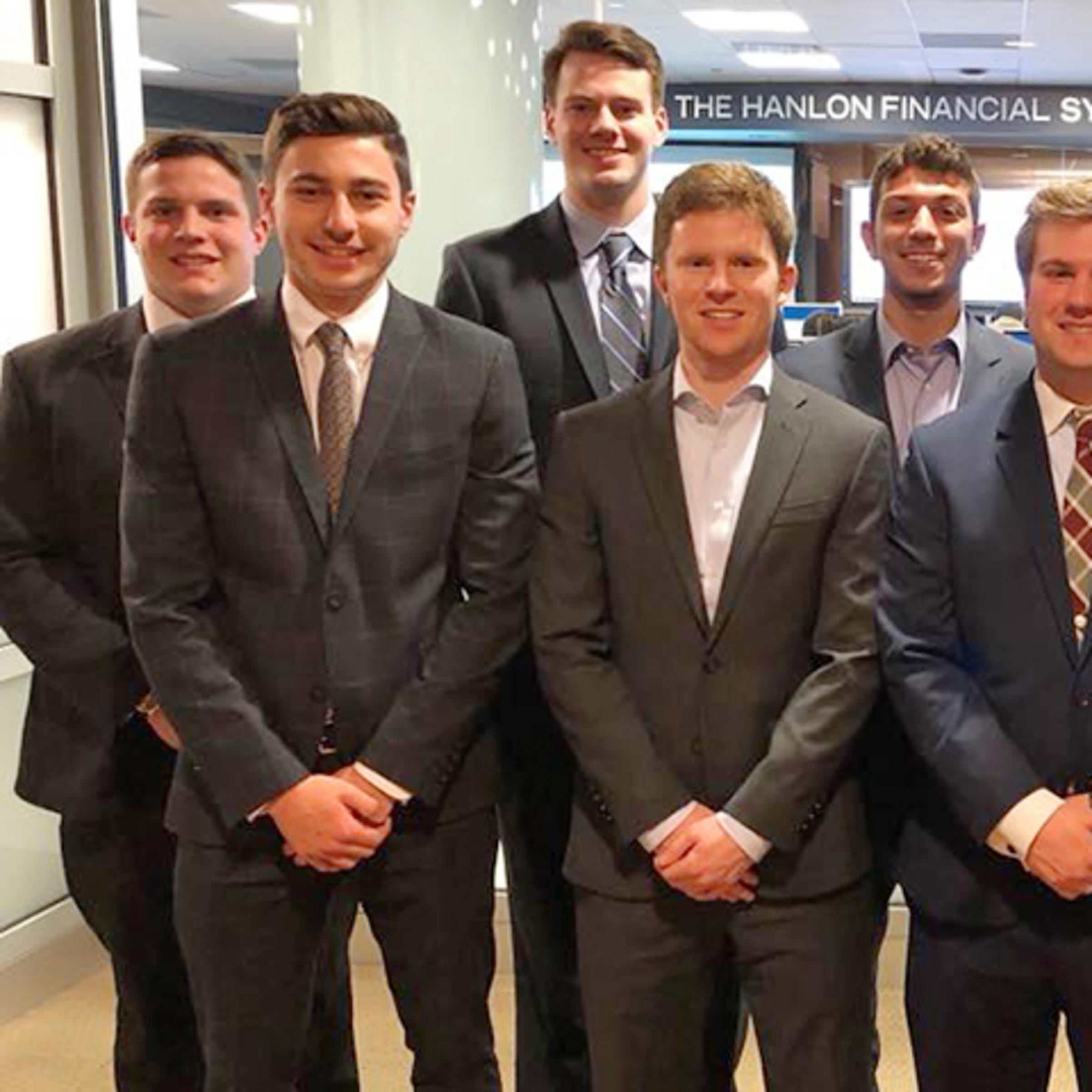 A group of students in professional dress outside the high-tech Hanlon Lab at Stevens.