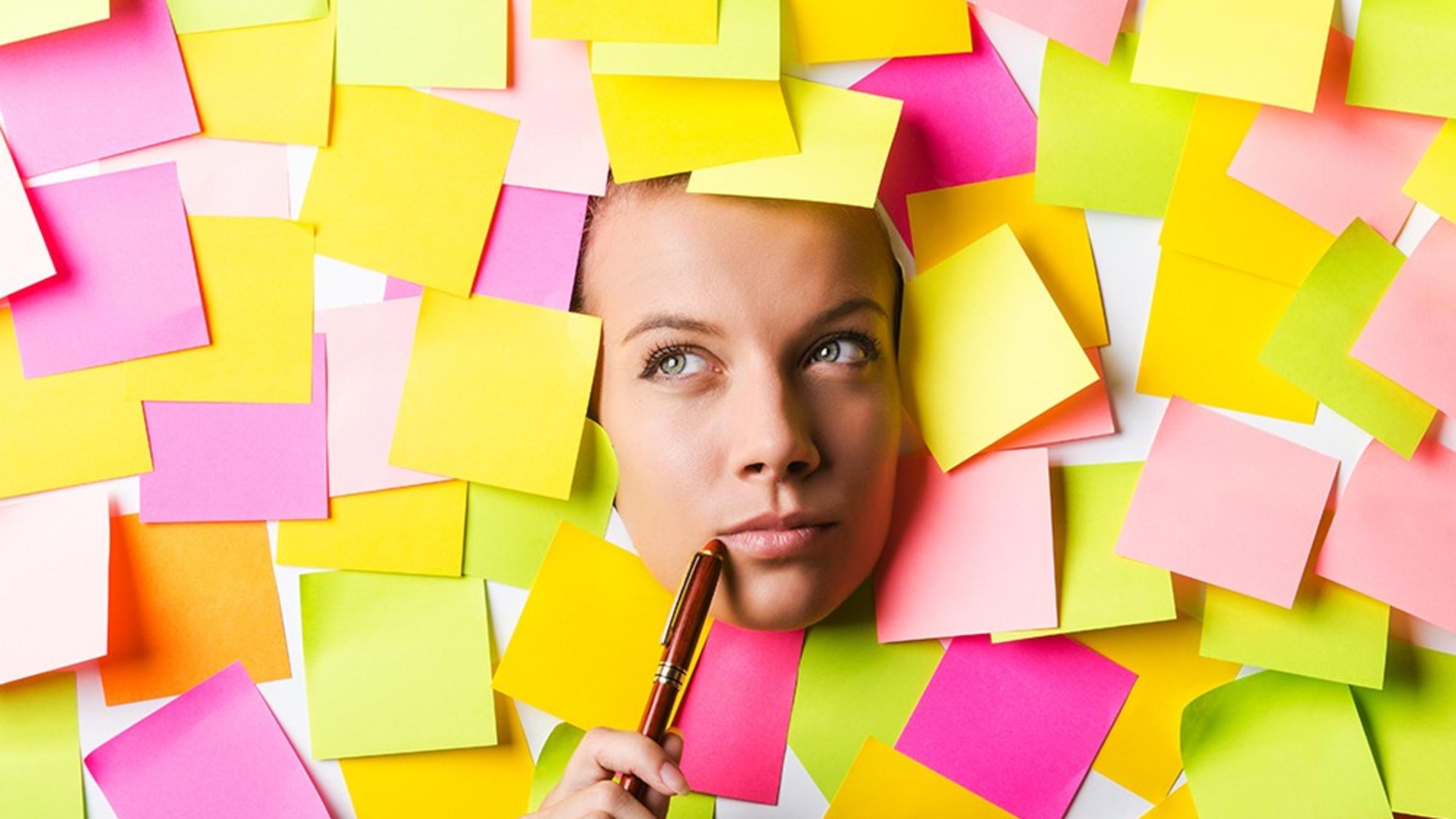 A woman's head surrounded by pink, green, yellow and purple post-it notes