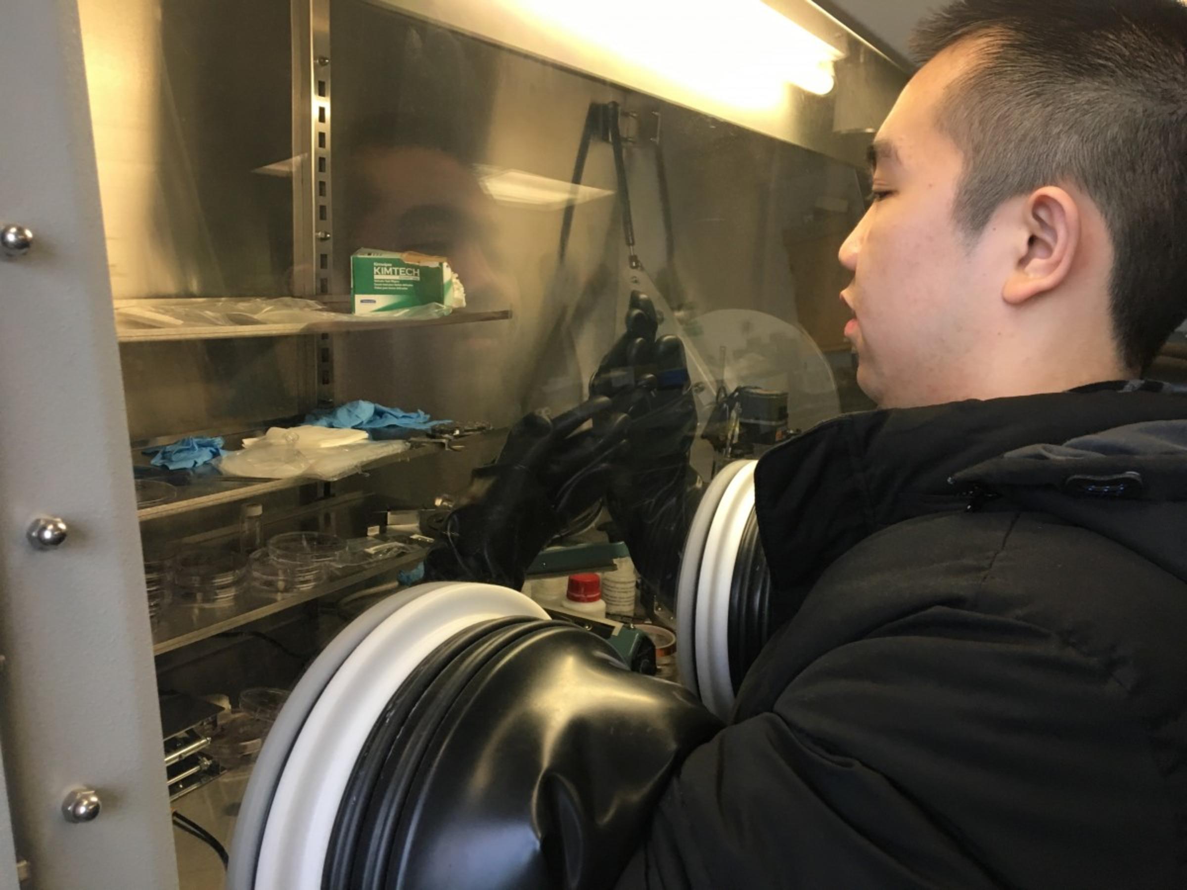 CAA student using a glovebox