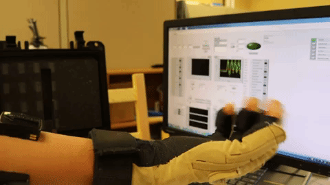 Vrajeshri Patel demonstrates the glove and its computer readouts