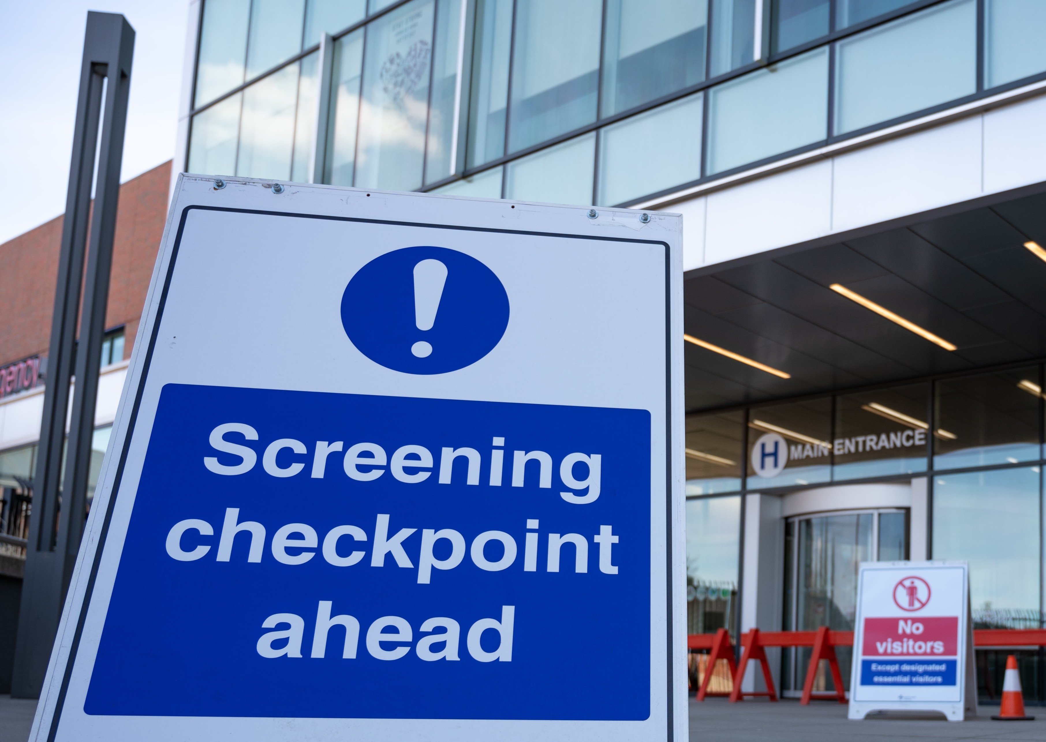 Hospital with sign indicating disease screening checkpoint