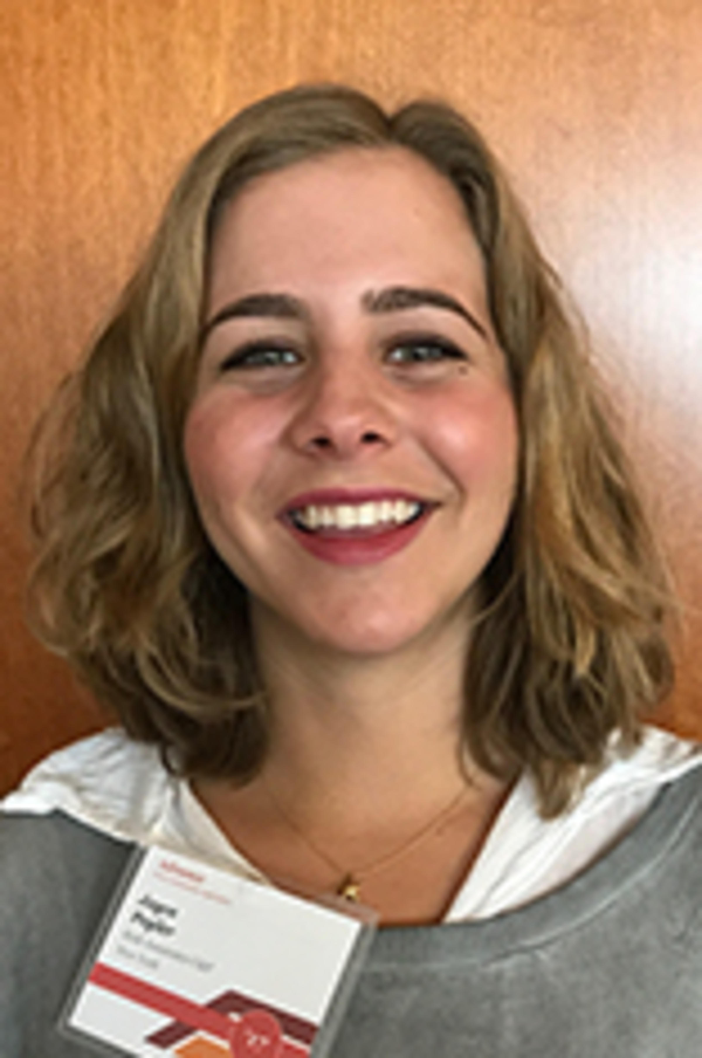 Headshot of Joyce Pegler in a white dress shirt with a gray cardigan.