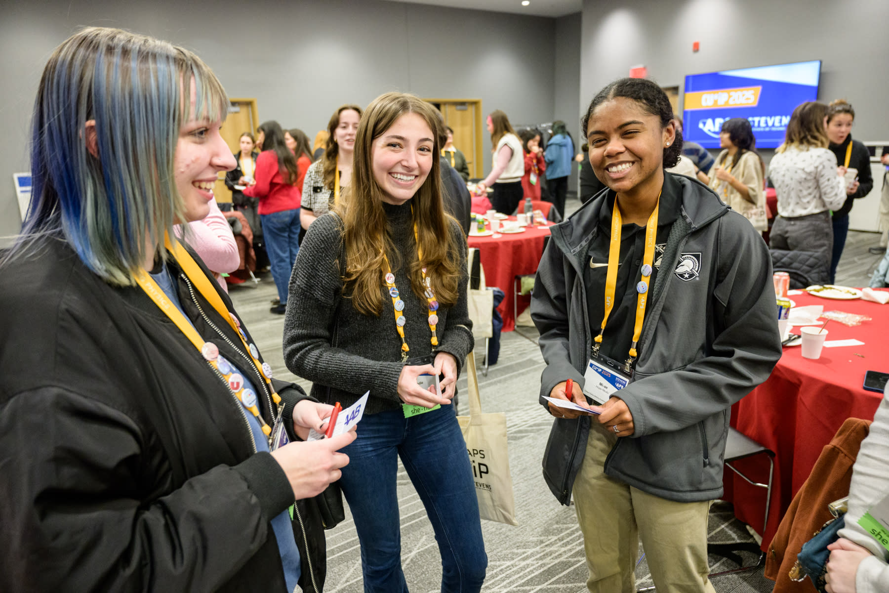 A group of students smiling in a conference room at Stevens Institute of Technology's 2025 CUWIP event.