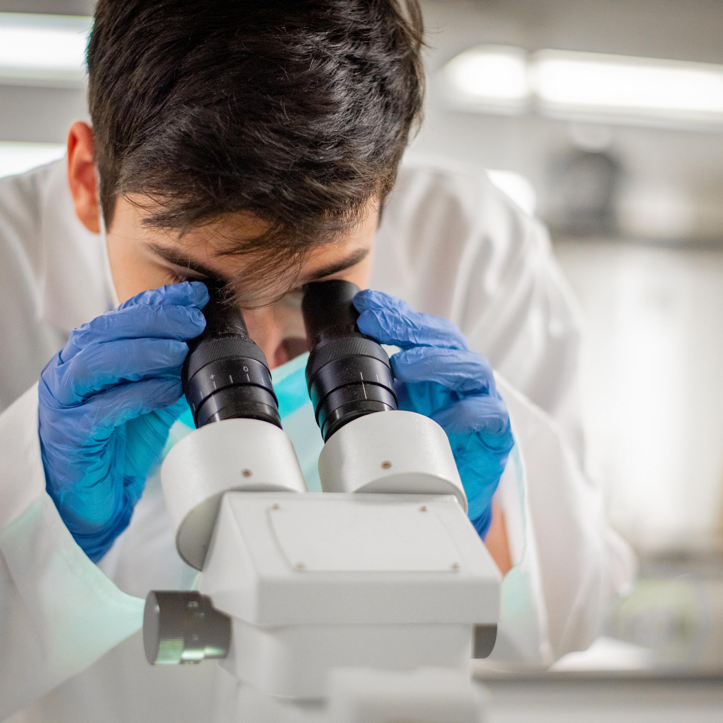 Student uses microscope in the lab