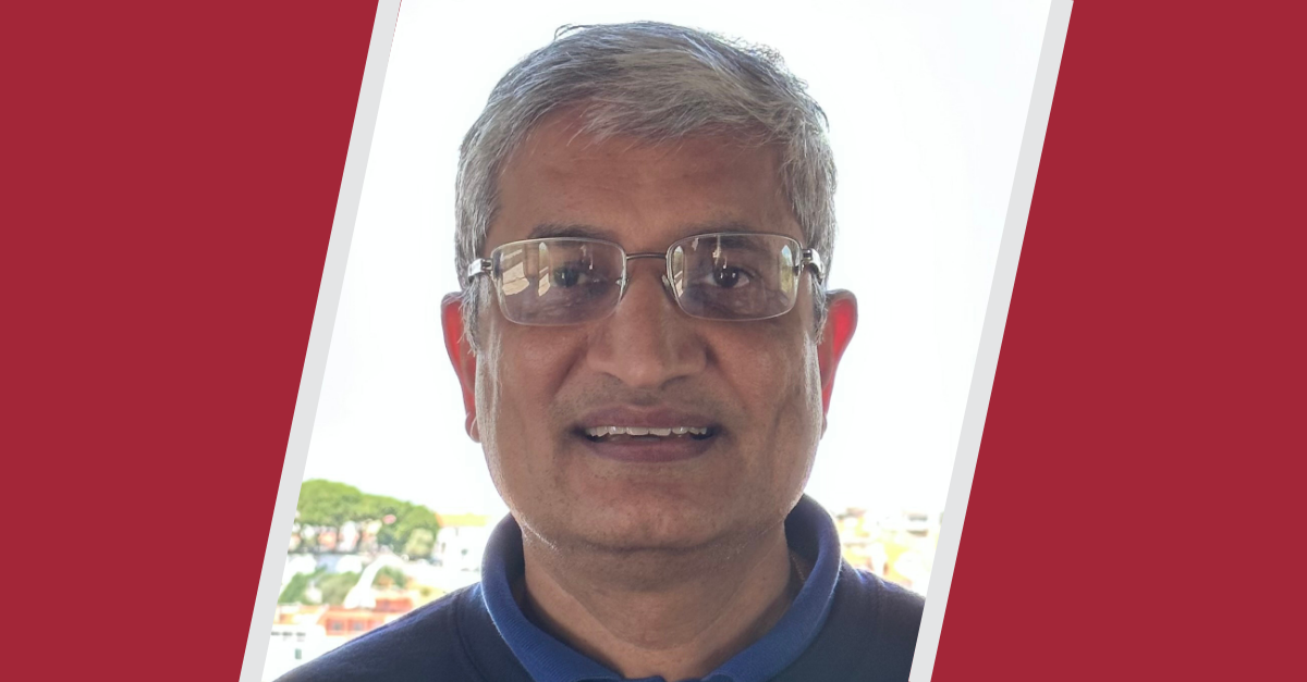Headshot of Sandeep Sacheti between two slanted red blocks with light gray lines bordering them.