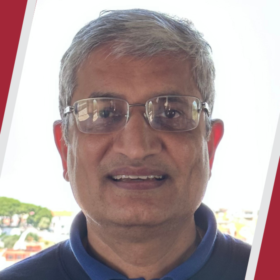 Headshot of Sandeep Sacheti between two slanted red blocks with light gray lines bordering them.