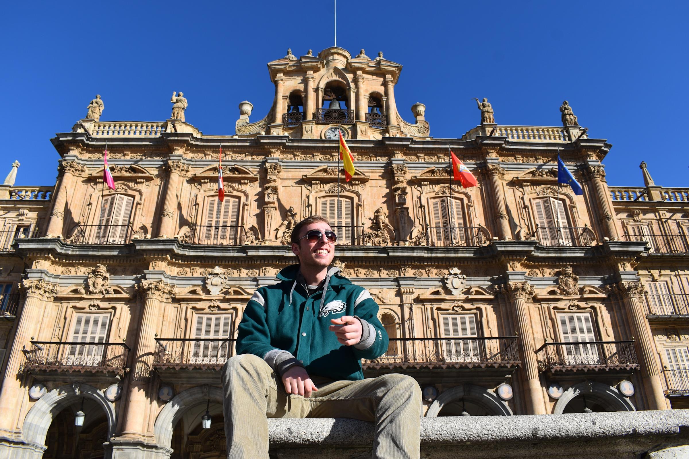Andon in Spain in front of building with flags