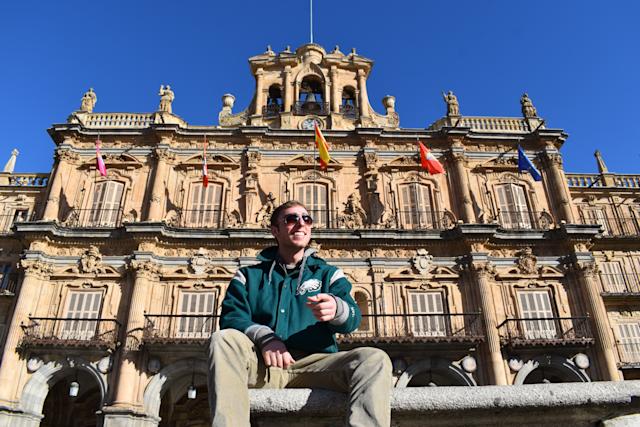 Andon in Spain in front of building with flags