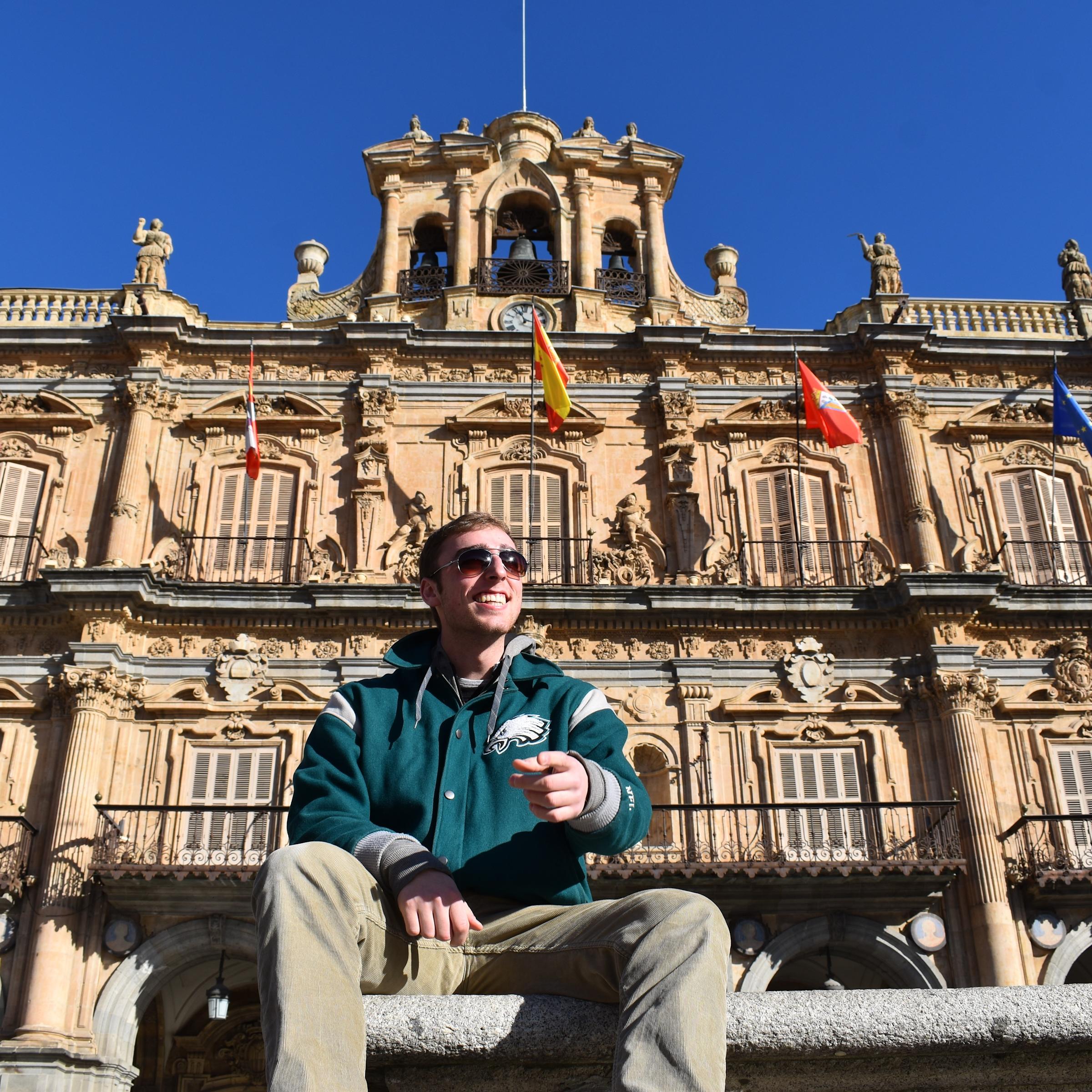 Andon in Spain in front of building with flags