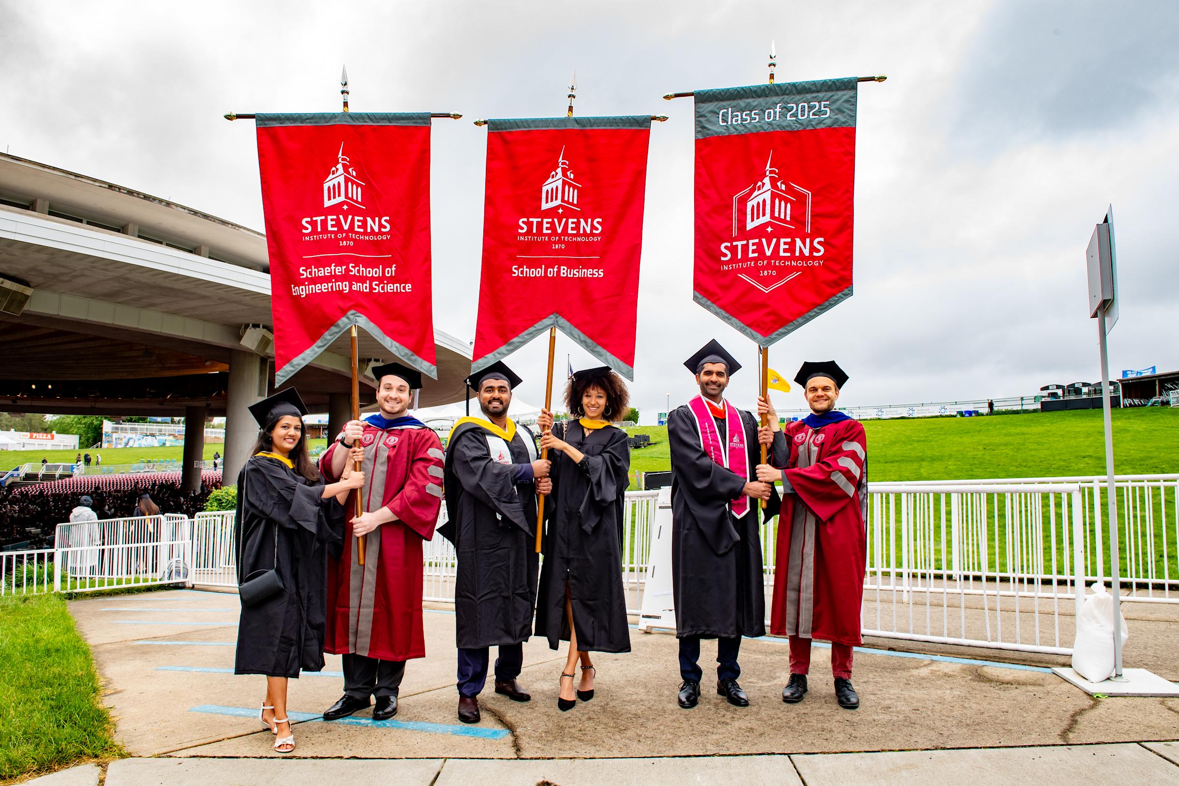 Six graduate student flag carriers pose for a photo.