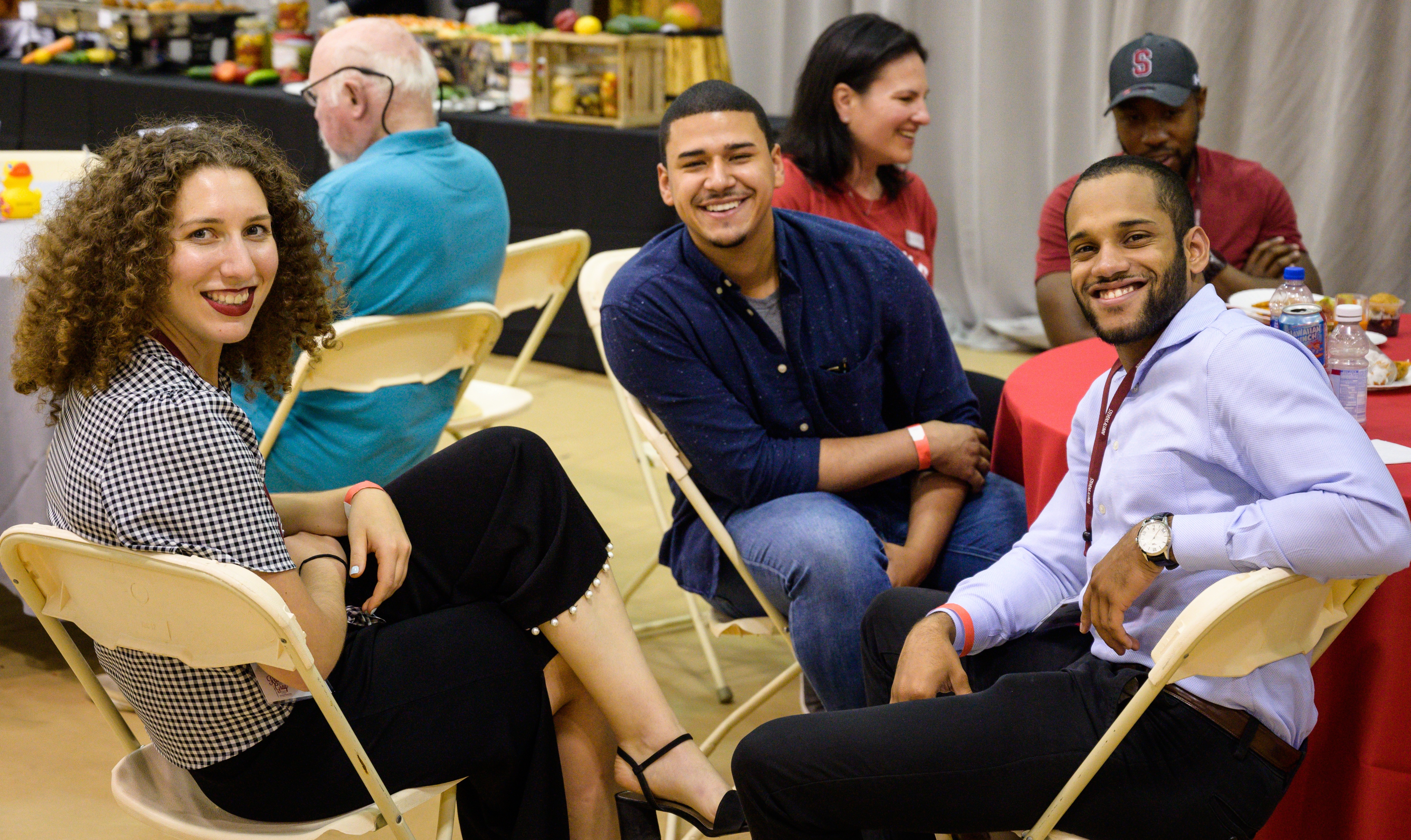 Young alumni smile at Alumni Weekend event