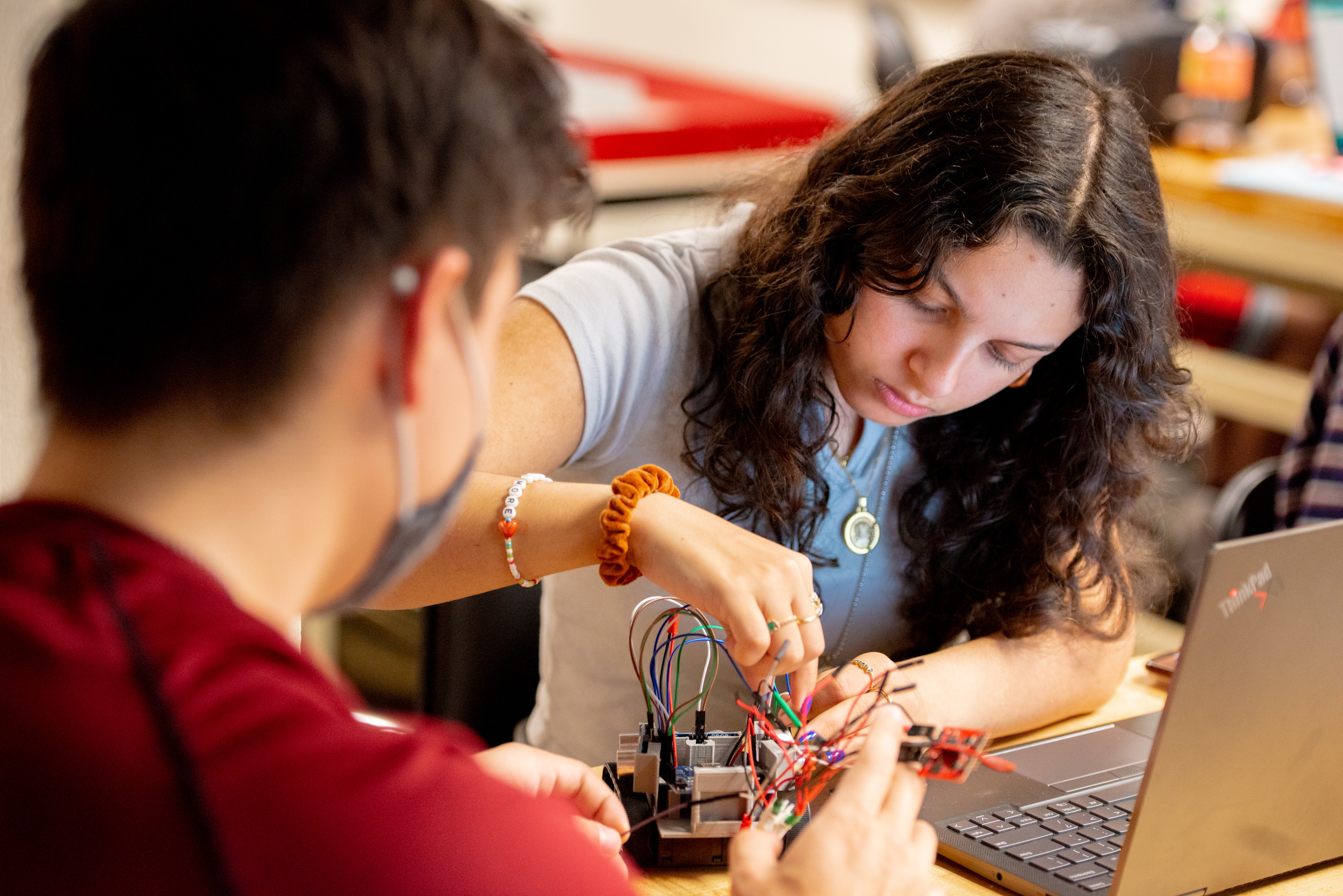 Two students working on a small robot