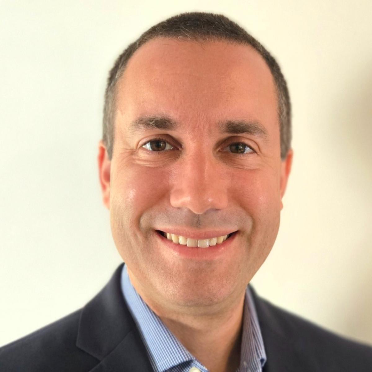 A photograph of Adam Hecht.
