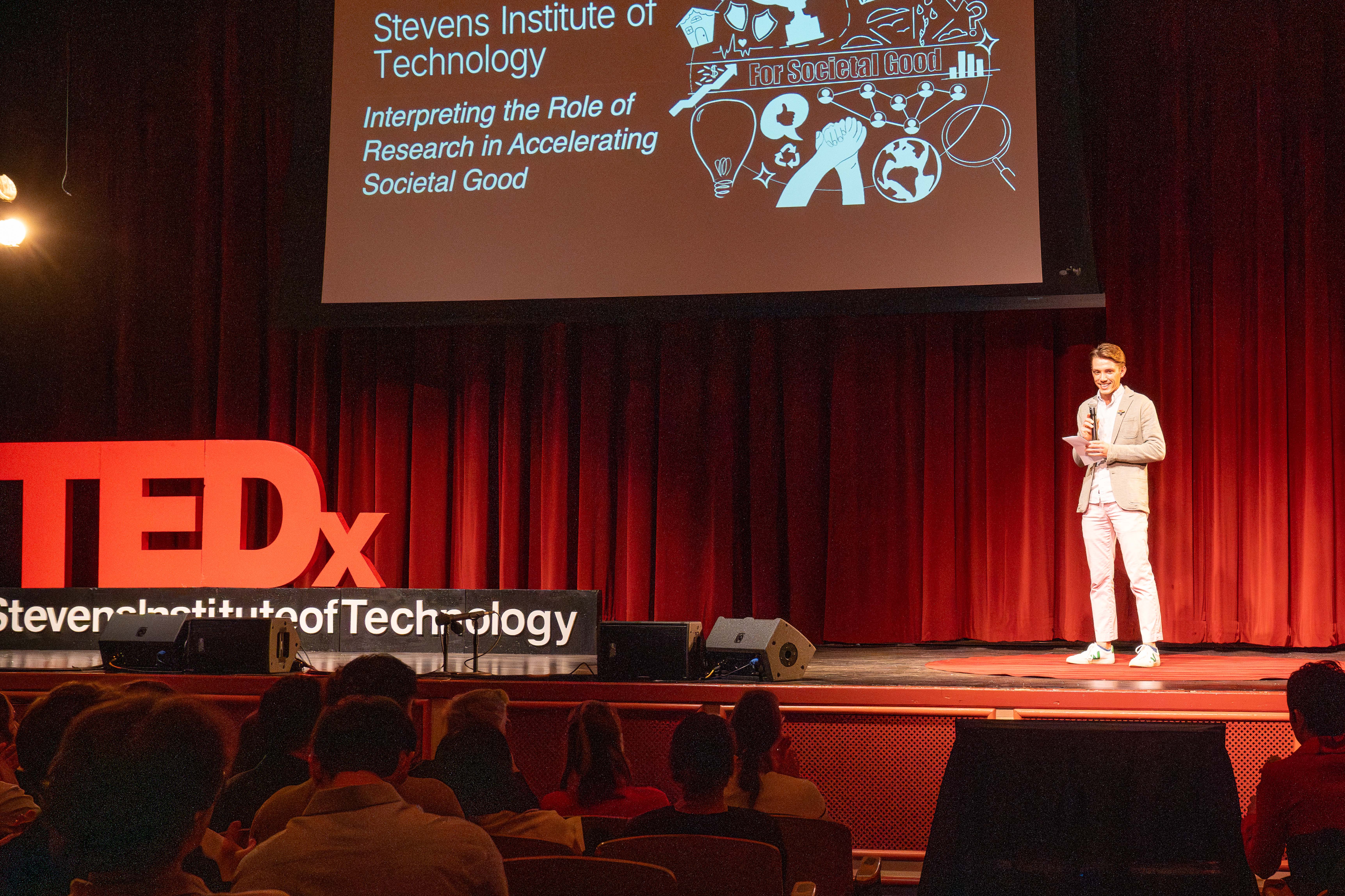 Nick Smith introduces the TEDx event to students, faculty and staff sitting in the DeBaun Auditorium