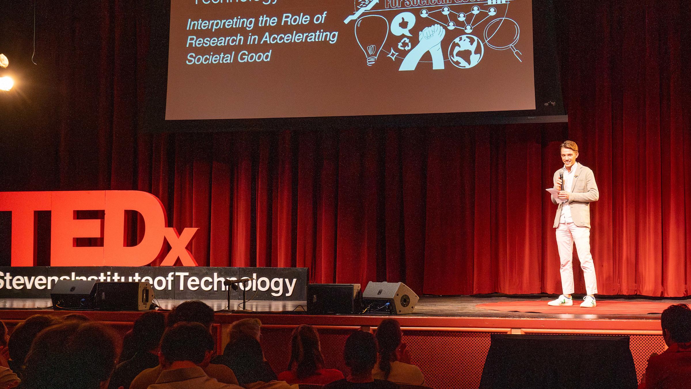 Nick Smith introduces the TEDx event to students, faculty and staff sitting in the DeBaun Auditorium