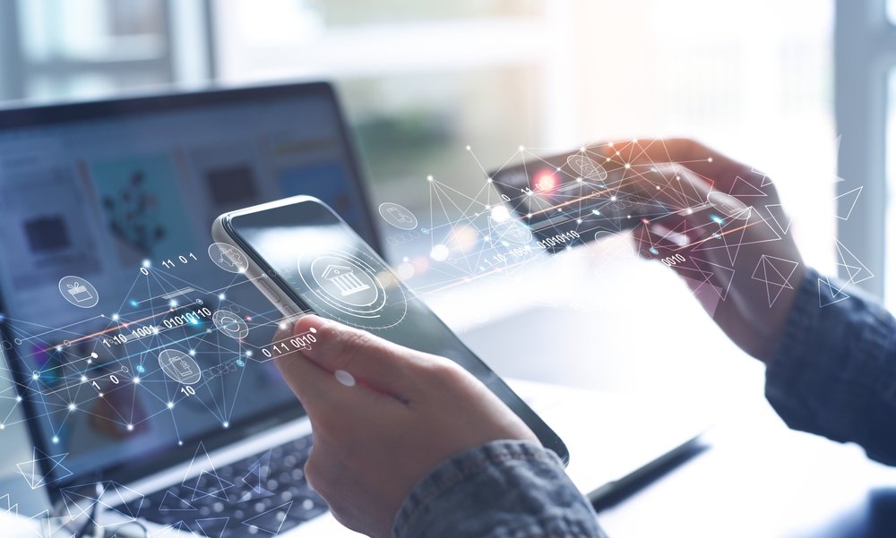 A person is holding a credit card in front of the phone