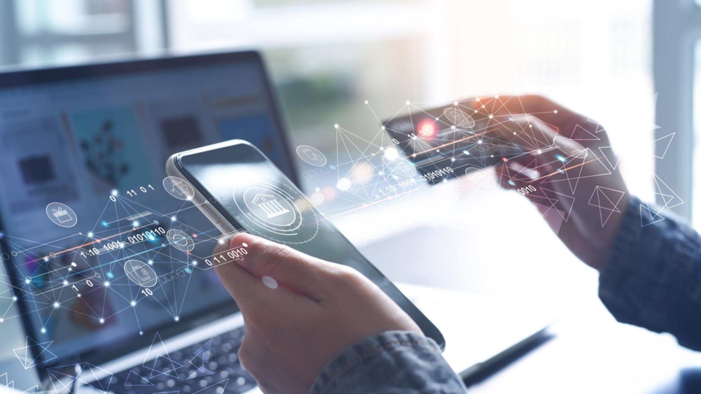 A person is holding a credit card in front of the phone