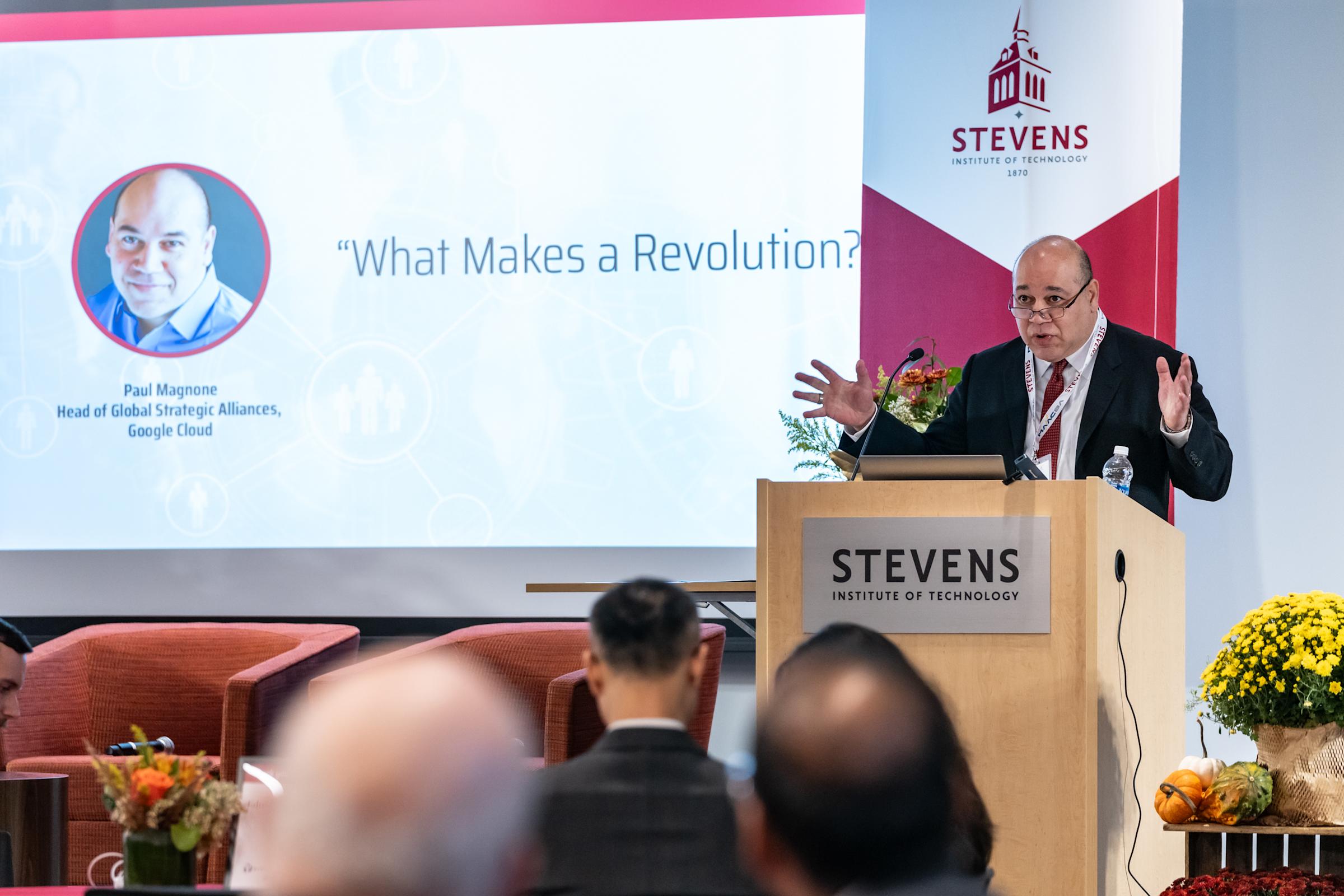 Paul Magnone stands behind a podium to address the 2023 MAACBA Conference.