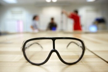 plastic goggles on wooden surface