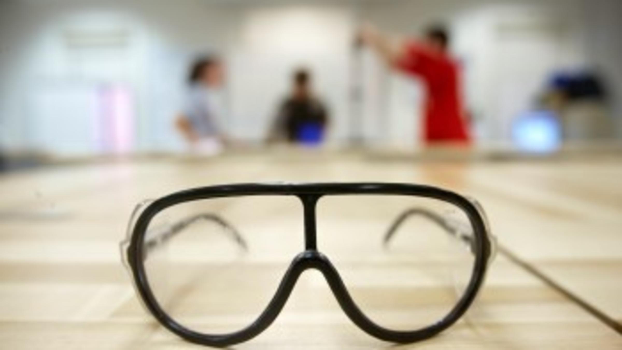 plastic goggles on wooden surface