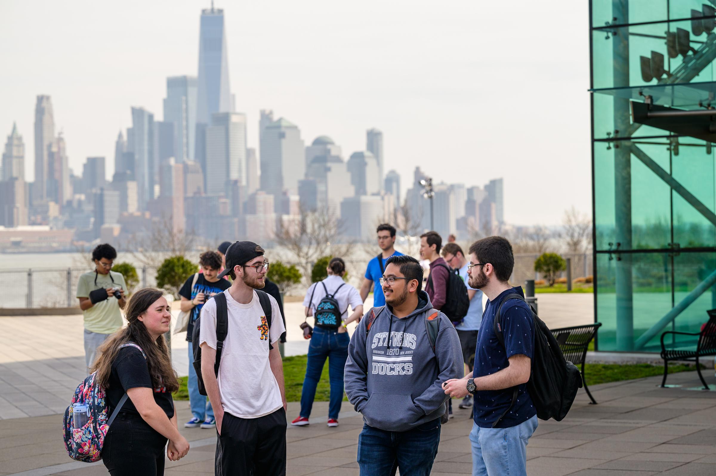 Students gathered at Babbio Patio overlooking the NYC skyline