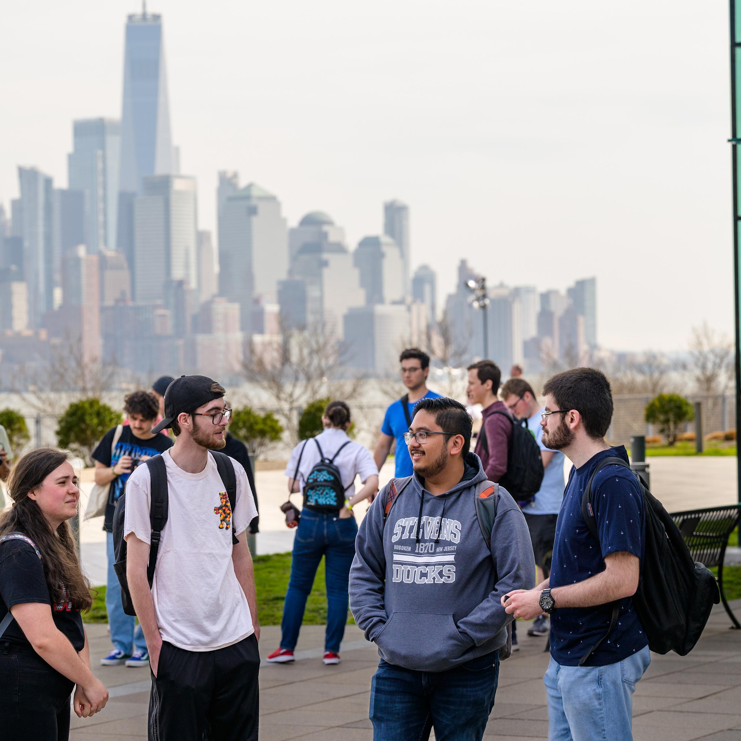 Students gathered at Babbio Patio overlooking the NYC skyline