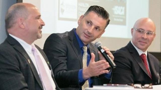 Three men at a table at the FinCyberSec conference
