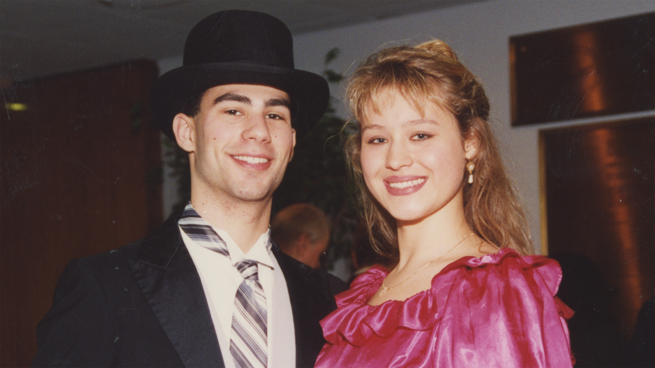A couple poses for a photograph in the 1980s