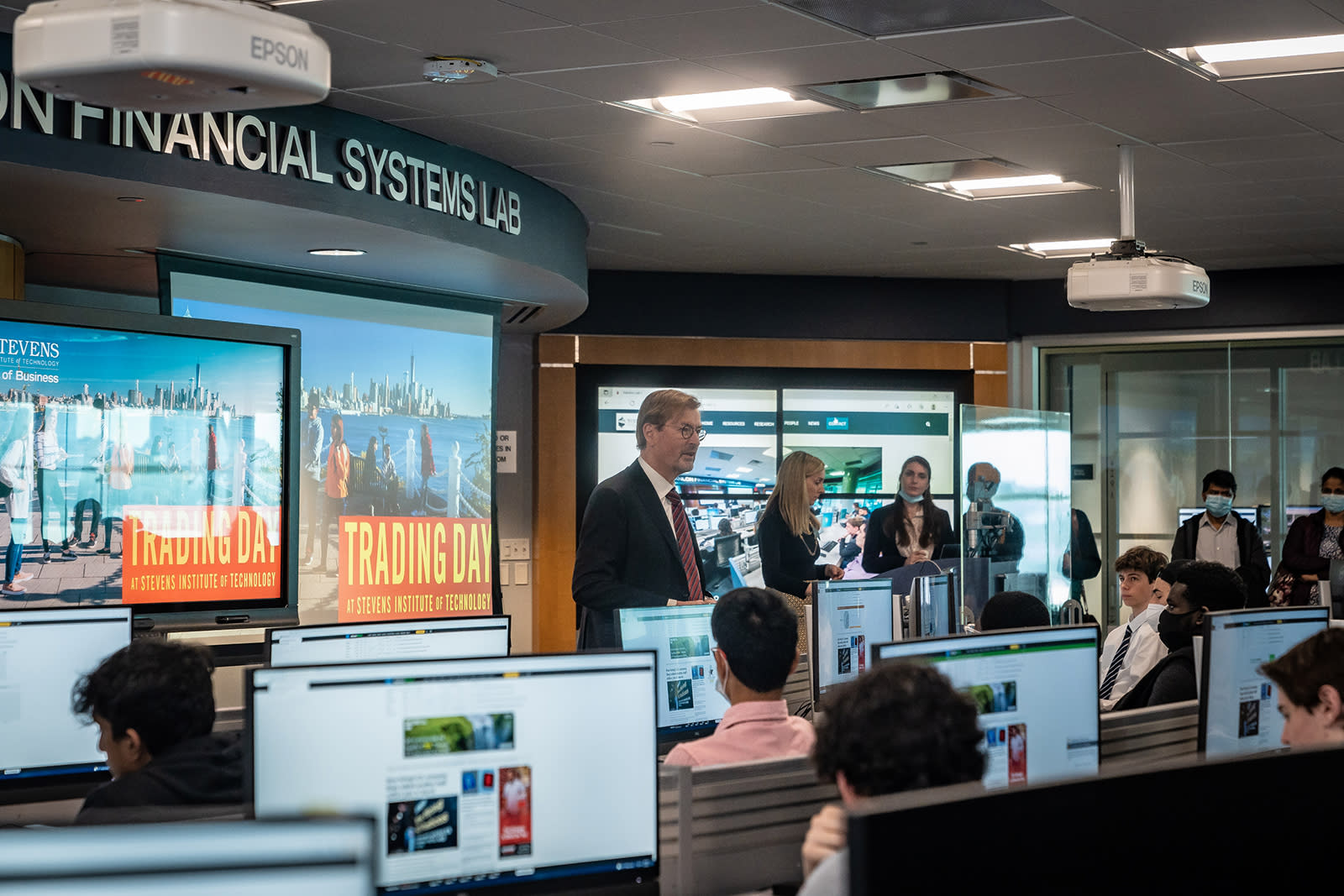 George Calhoun and Lindsay Hartelius in front of students during Trading Day