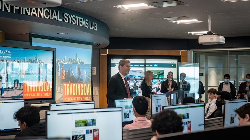George Calhoun and Lindsay Hartelius in front of students during Trading Day