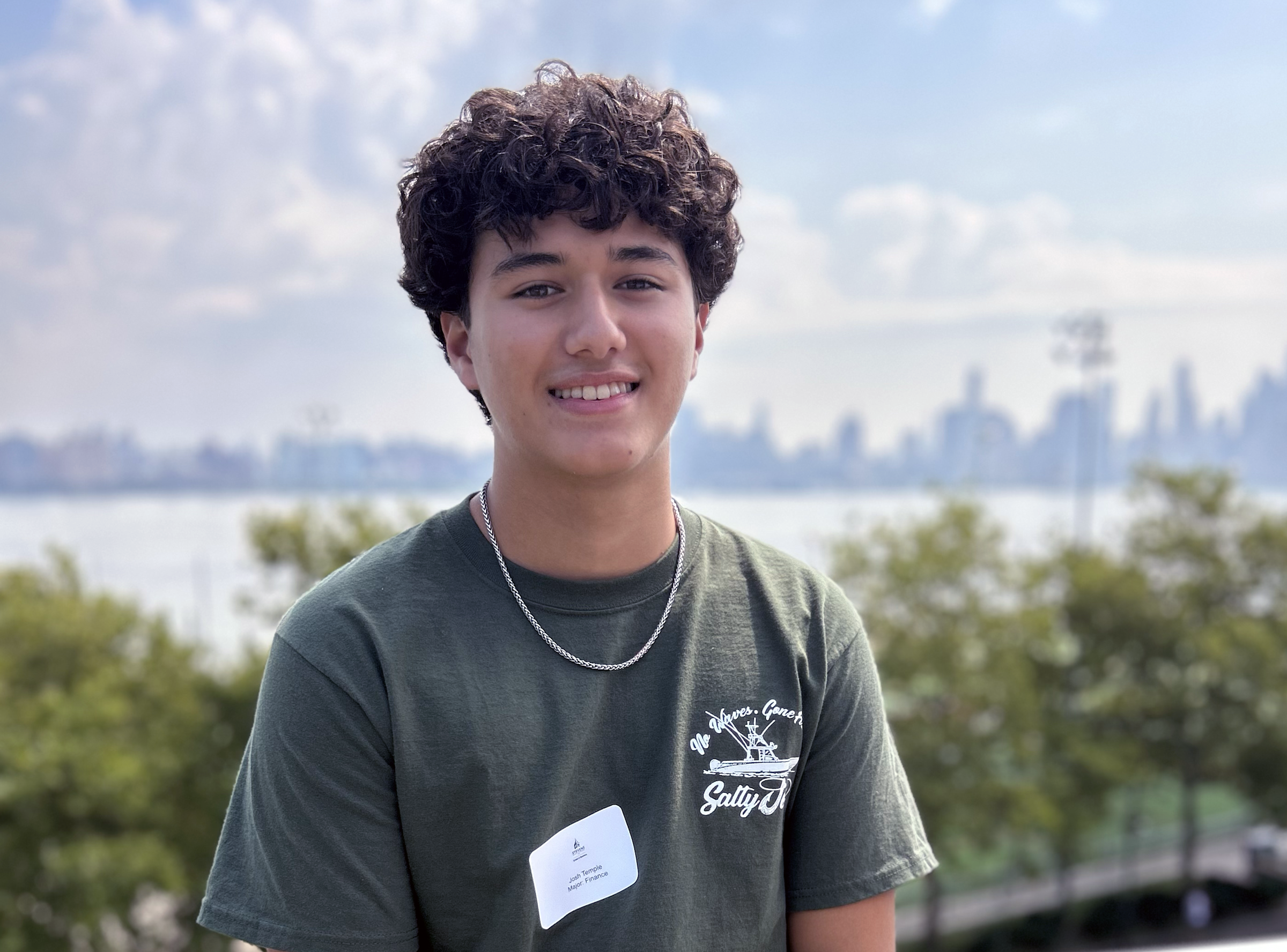 Josh Temple stands on the Babbio Center patio.